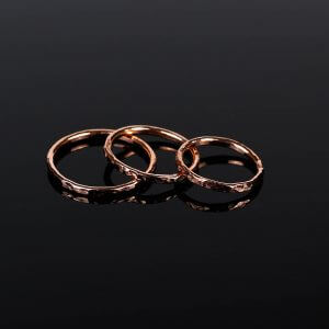 3 hammered copper stacking rings on black background