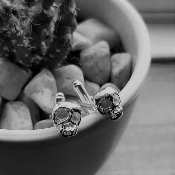 memento mori cufflinks on plant pot in black and white