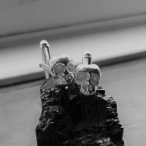 memento mori cufflinks on black crystal in black and white
