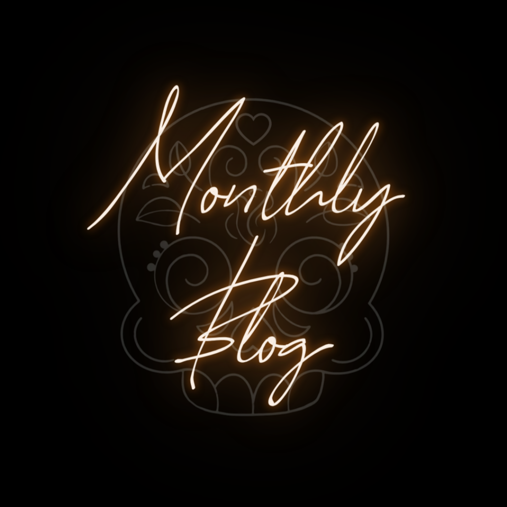 Monthly blog wording over sugar skull logo