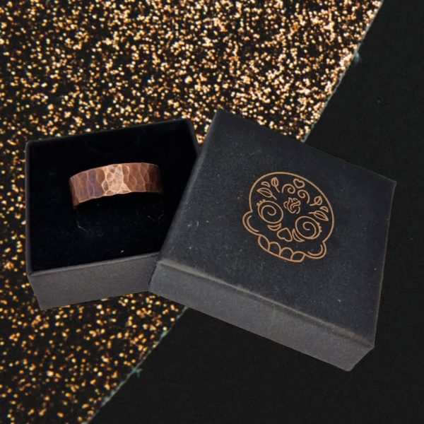 hammered chunky copper ring displayed in a black jewellery box sitting on a black and copper glittery background