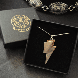 Silver and copper lightning bolt necklace on a silver chain in a black jewellery box with cowboy hat