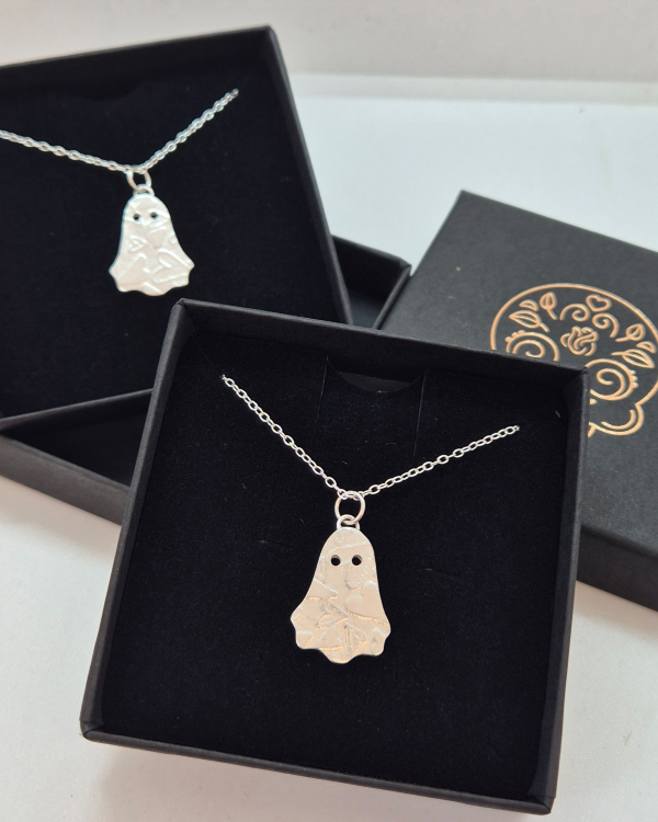2 silver ghost necklaces in black jewellery boxes