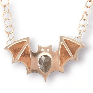 copper and silver bat necklace with grey moonstone belly and diamond eyes on mixed metal chain