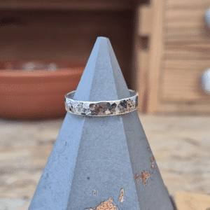 silver hammered textured wide ring band on ring cone