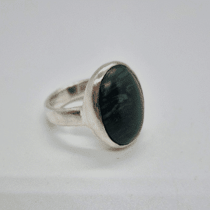 chunky dark green malachite stone set in a sterling silver band on a white background