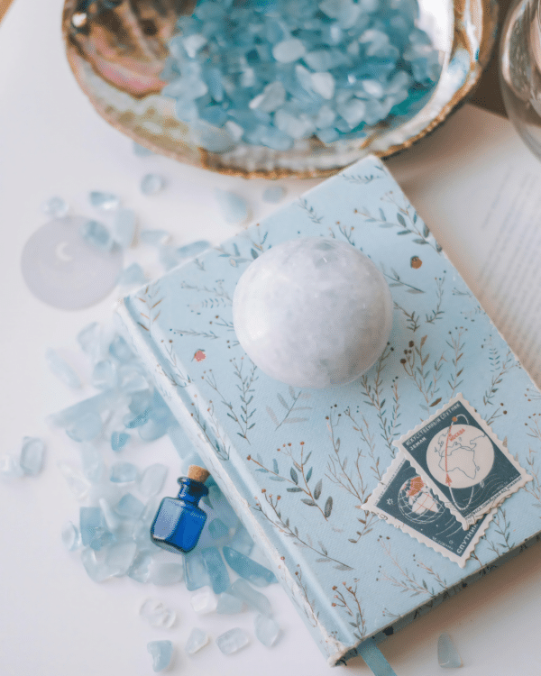 blue crystals laid on notepad