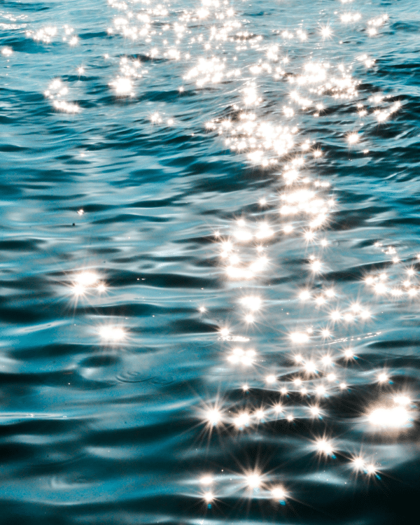 blue sea waves with the sun shining on them