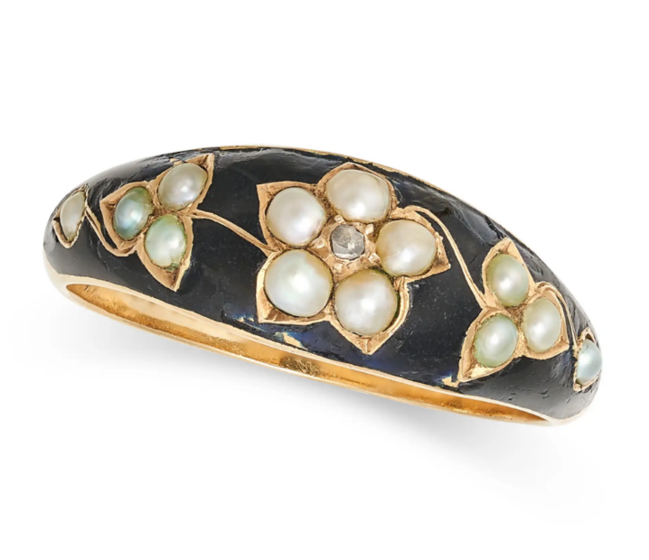 a black enamelled gold ring set with pearls in a floral pattern