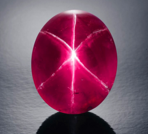 Pinky red gemstone with 6 lines of white