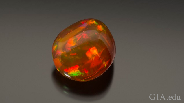 orangey red opal on grey background