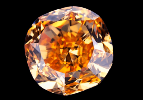 Bright orange round diamond on a black background