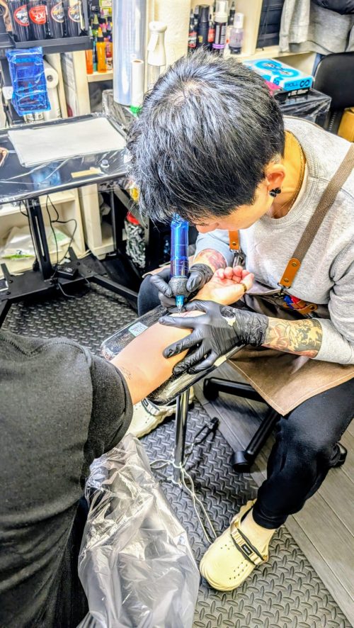 Women being tattooed on arm