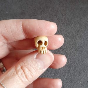 memento mori skull bead held in hand