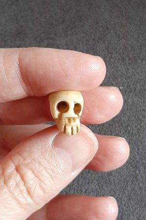 memento mori skull bead held in hand